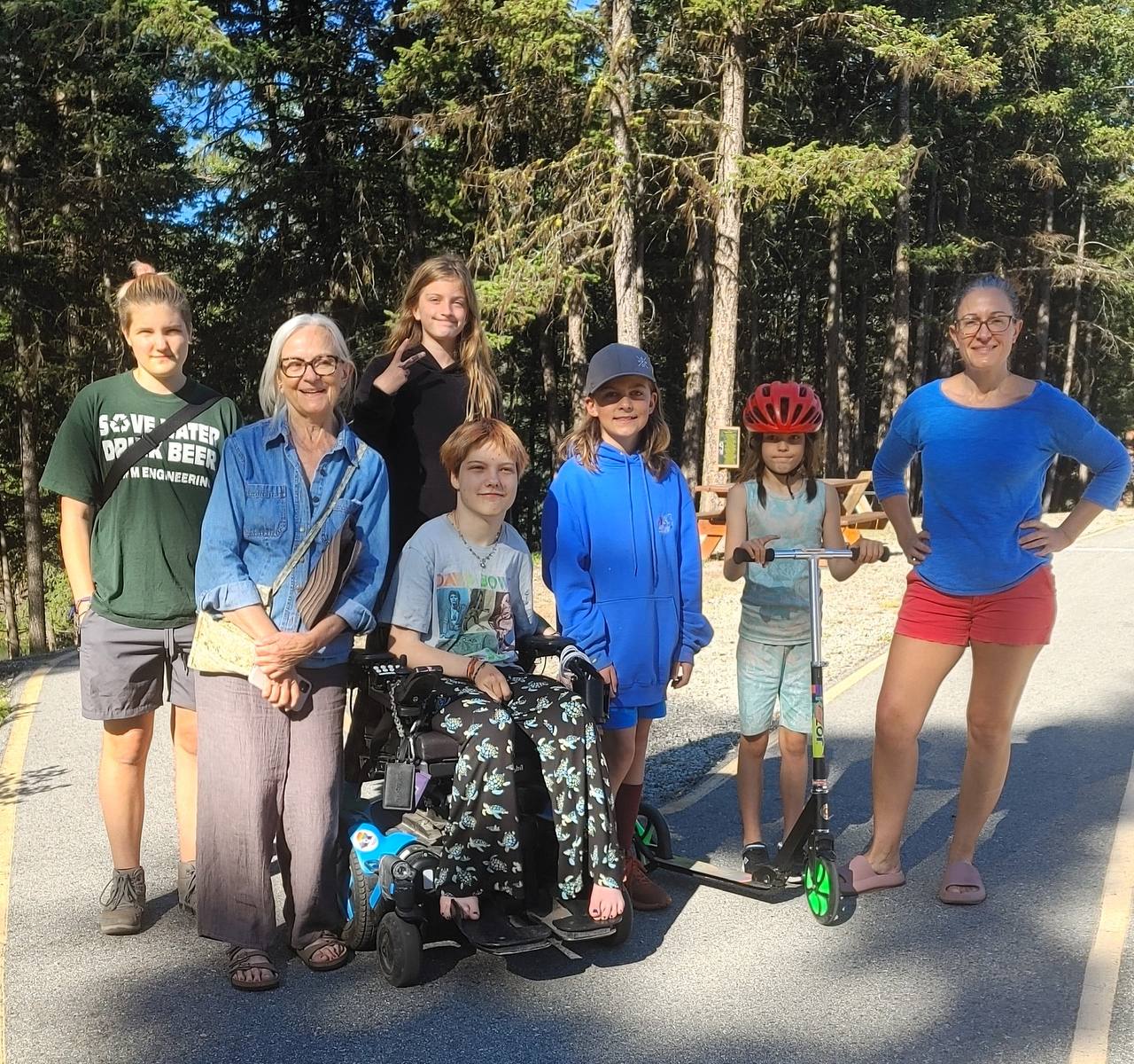 Multi-generational family group on the fully paved accessible paths at Agur Lake Camp